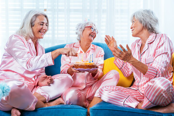 Wall Mural - Beautiful senior women having funny pajama party at home - Group of cheerful elderly female friends having fun at home and celebrating birthday, concepts about old people, lifestyle, quality of life