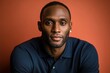 © NicotineLens  - Confident Black Man Portrait Against Orange Background