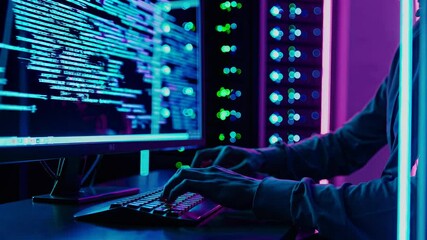 Fototapete - Computer hacker engaged in coding at night in a dimly lit room filled with servers