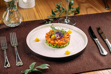 Wall Mural - Portion of gourmet salmon tartare with chopped avocado and sauce