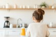 © Avelvet - Young girl sitting at a kitchen table, enjoying a drink while the cozy kitchen is in the background