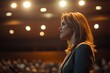 © Marina - Confident speaker engages audience under warm stage lights, capt