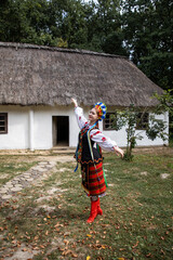 Woman in traditional costume dancing. Ukrainian woman. A young woman in a national Ukrainian costume. Embroidery. Ukrainian national clothing.