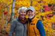 © Markus Schröder - Portrait of a grinning caucasian couple in their 80s wearing a lightweight running vest isolated in background of autumn leaves