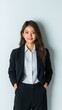 © Marina Varnava - Professional Asian female butler opening a door in a formal setting on a white background