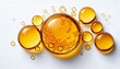 © OZartanimation - Golden yellow drops of essential oil on a white background. Basic ingredients in skincare or haircare cosmetics like niacinamide, omega-3, retinol, biotin, keratin, lipids, ceramides, urea, collagen