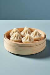 Sticker - there is a wooden bowl filled with dumplings on a blue surface