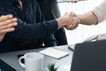 Fototapete - Diverse group of office employee worker shake hand after making agreement on strategic business marketing meeting. Teamwork and positive attitude create productive and supportive workplace. Prudent
