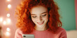 © smth.design - Red haired caucasian young woman smiling while using smartphone indoors