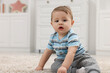 © New Africa - Adorable baby boy on floor at home