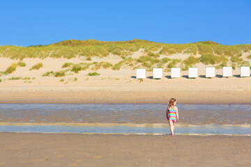 Wall Mural - Kids playing on beach. Children play at sea.