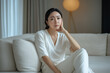 © amila - Sad Depressed Middle Age House Wife Sitting on Living Room Sofa