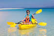 © famveldman - Kids kayaking in ocean. Family in kayak in tropical sea