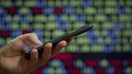 Phone smartphone at night office, Man work with chatbot AI online, connecting with AI and using a chat bot. IT engineer software developer programmer interact with chat bot, making writing code