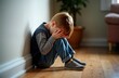 © Pete - Sad boy sits on floor with head in hands. Child appears upset, stressed. Indoor setting suggests home environment. Possible issues include bullying, depression family problems. Child seems anxious