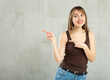 © JackF - Smiling young woman in casual clothes gesturing in studio