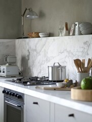 A kitchen with a white marble wall and a stove with a pot on it. The kitchen is well-organized and clean