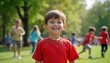© Pete - Young boy wearing red shirt smiles happily in park. Other children play, watch in background. Outdoor summer fun. Joyful, carefree childhood moments. Park scene shows carefree kids playing outdoors.