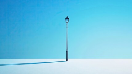 Wall Mural - minimalist street lamp casting a long shadow under a clear blue sky, evoking simplicity and elegance