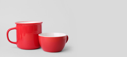 Wall Mural - Red ceramic cups on grey background