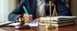 © Pete - Judge writes legal document. Wooden gavel, golden scales of justice rest on desk. Pro lawyer reviews documents. Legal work in progress. Authority figure. Fair trial concept. Business, law intersect.