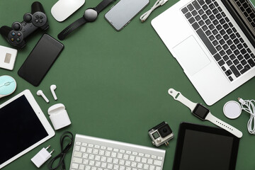 Wall Mural - frame made of modern devices on dark green background