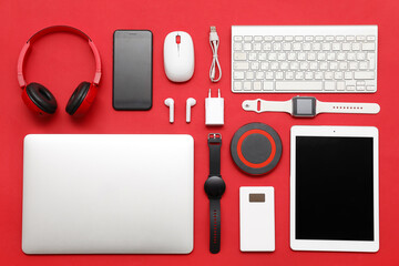 Wall Mural - set of modern devices on red background, top view