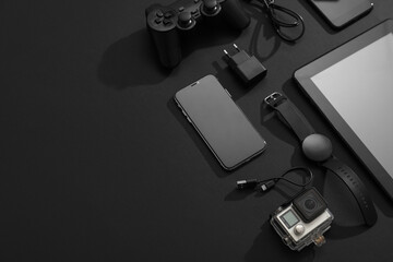 Wall Mural - many modern devices on black background