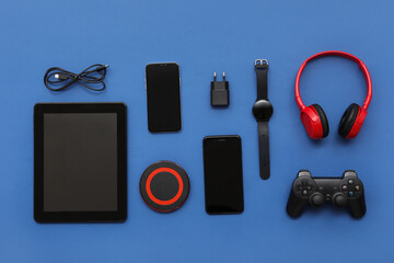 Wall Mural - composition with different modern gadgets on blue background