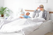 © Pixel-Shot - Displeased mature woman with her snoring husband in bedroom