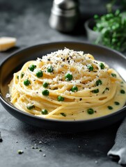 Poster - A bowl of pasta with peas and cheese. The dish is creamy and looks delicious. The bowl is black and the pasta is yellow