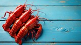 Three vibrant red crustaceans arranged on a weathered blue wood surface