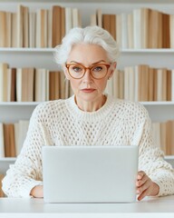 Fototapete - Scandinavian Remote Learning Mature White Woman, 35, Engaged at Minimalist Library Desk with Textured Sweater and LaptopEducation Tech and Digital Coaching for Business Growth