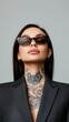 © Sergio - Confident model poses fashionably in stylish sunglasses against a minimalist background
