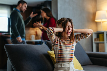 Wall Mural - A neglected, frustrated teenager while her parents struggle with relationship problems and argue