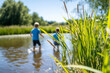 © Juri - Children play in the pond in sunny weather.