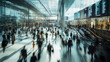 © juancajuarez - Crowded airport terminal with blurred motion of travelers walking, carrying luggage, and using escalators under bright natural light - travel concept
