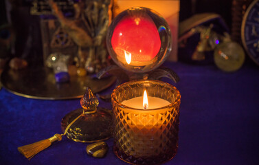 Wall Mural - Esoteric concept, some witch stuff on altar. Candle burning on a table