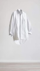 Aufkleber - Crisp white shirt floats effortlessly in a minimalist room, showcasing a unique and surreal concept against a plain white wall and light wooden floor