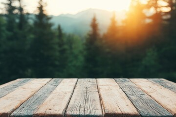 Wall Mural - Empty wooden table showing a blurred mountain forest in background at sunset