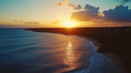 Wall Mural - Dramatic sunset over a tranquil beach, with golden hues blending into deep blue and purple tones