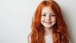 © The 2R Artificiality - Positive young girl with long red hair smiling joyfully in a bright white studio, emphasizing hair care and vibrant personality.