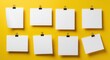 © Isolated Art - Eight Blank White Paper Sheets with Black Binder Clips on Yellow Background