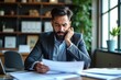 © SimpleDesignStudio - A Businessman in a Modern Office Frowning While Reviewing Important Documents Amidst a Contemporary Workspace with Plants and Organised Shelving