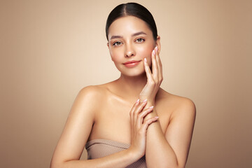 Wall Mural - portrait beautiful young woman with clean fresh skin. model with healthy skin looks at an empty spac