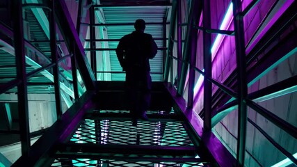 Poster - Exploring an industrial corridor with vibrant lighting at night in an urban setting