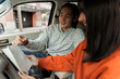 © Maria Vitkovska - Driving instructor explaining lesson to student using notepad in car