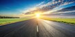 © sasiprapa - Asphalt road stretching towards a vibrant sunset over a field