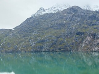 Natural landscape of Alaska lake and snowcapped mountains