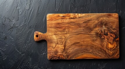 Sticker - Wooden cutting board on gray stone surface against black background for food prep display.